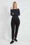 Woman wearing the Ponte Petal-Vent Button-Tab Slim Pant in Black.