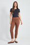 Woman wearing the Suede Petal-Vent Slim Pant in Tobacco.