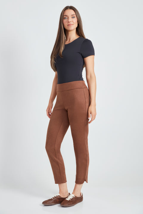 Woman wearing the Suede Petal-Vent Slim Pant in Tobacco, side view.