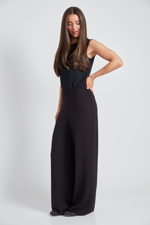 Woman wearing the Provence Wide-Leg Pant in Black, side view.