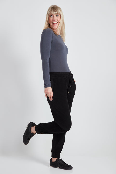 Woman wearing the Knit Corduroy Jogger in Black, side view.