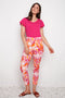 Model wearing UP! Sunset Techno Petal-Slit Ankle Pant in Sunset print, front view.