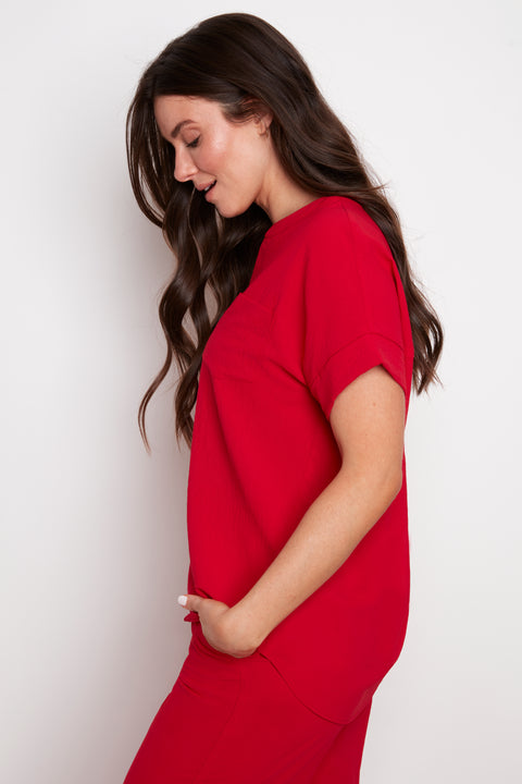 Side view of model wearing UP! Air Flow Short Sleeve Top in Strawberry.