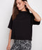 Model wearing UP! Provence Short Sleeve Top in Black, front view.