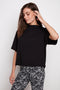 Model wearing UP! Provence Short Sleeve Top in Black, front view.