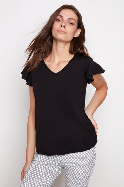 Model wearing UP! Provence V-Neck Ruffle Sleeve Top in Black, front view.