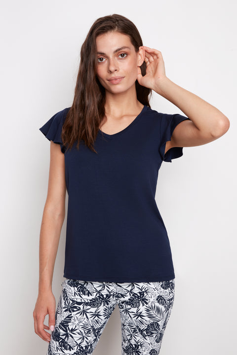 Model wearing UP! Provence V-Neck Ruffle Sleeve Top in Navy, front view.