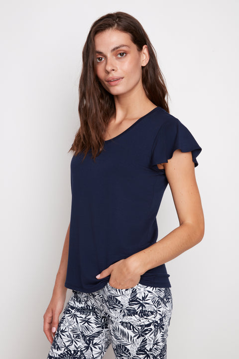 Side view of model wearing UP! Provence V-Neck Ruffle Sleeve Top in Navy with ruffle sleeve detail.