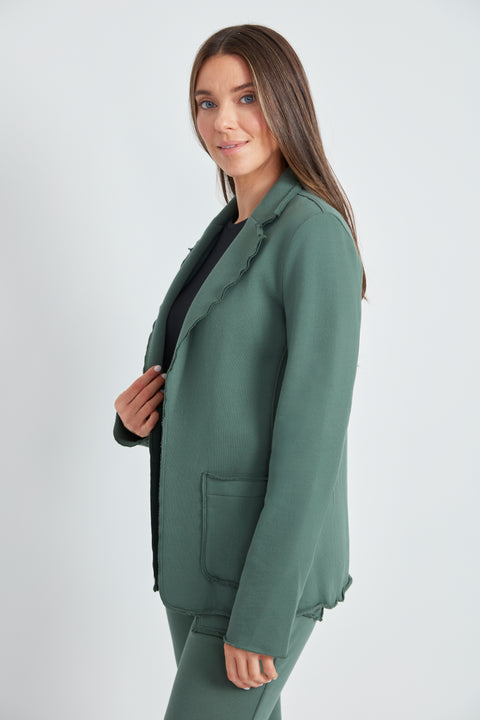 Woman wearing the French Terry Raw Edge Blazer in Ivy Green, side view.