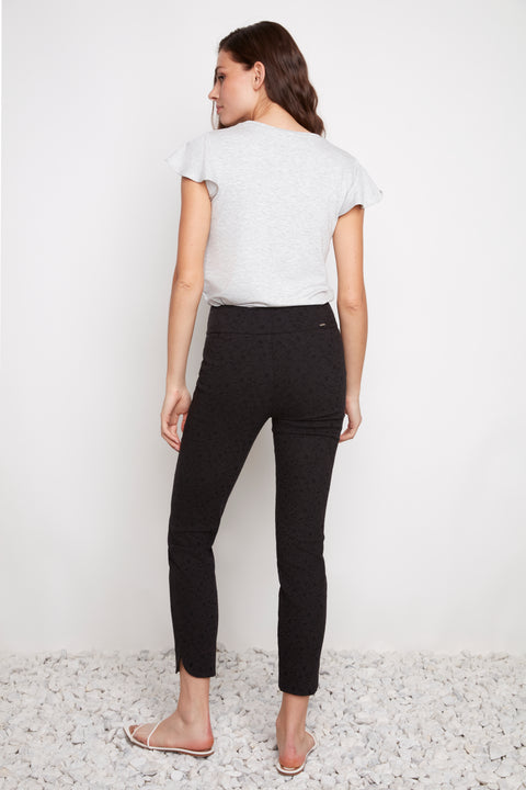 Back view of model wearing UP! Textured Techno Petal-Slit Ankle Pant in Black Loom.