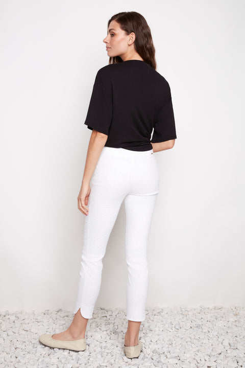 Back view of model wearing UP! Textured Techno Petal-Slit Ankle Pant in White Loom.