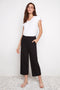 Model wearing UP! Textured Techno Wide Leg Crop Pant in Black Loom, front view.