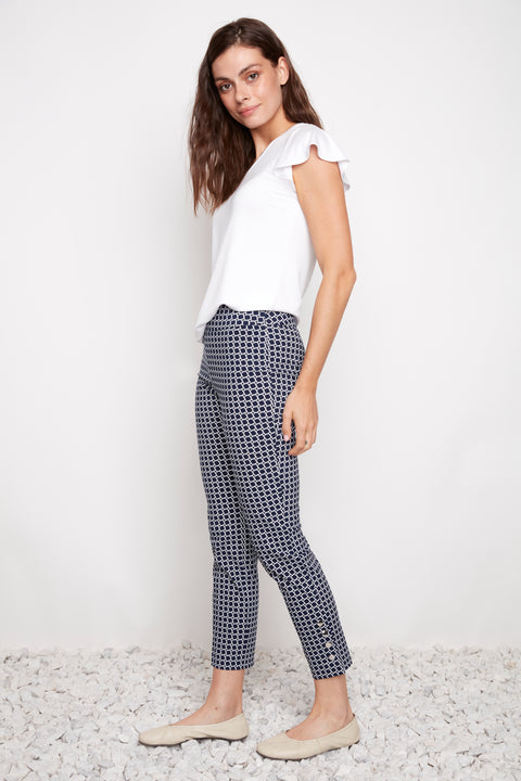 Side view of model wearing UP! Coastal Techno Button-Vent Ankle Pant in Blue Coastal print with button vent detail.