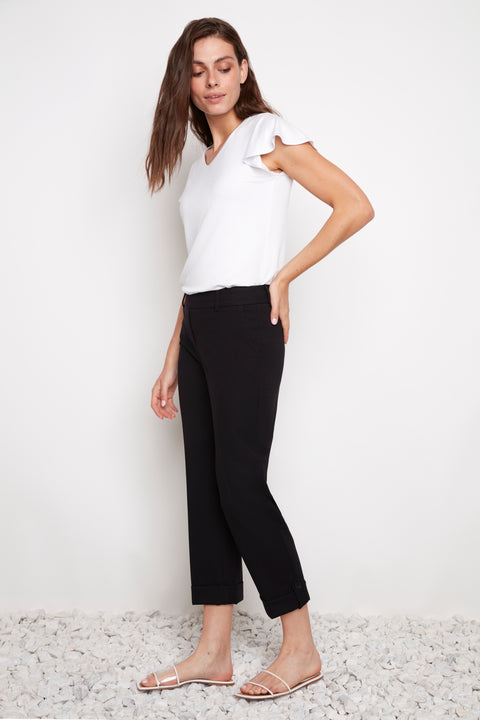 Side view of model wearing UP! Compression Techno Button-Cuff Straight Leg Crop Pant in Black with button-tab cuff detail.