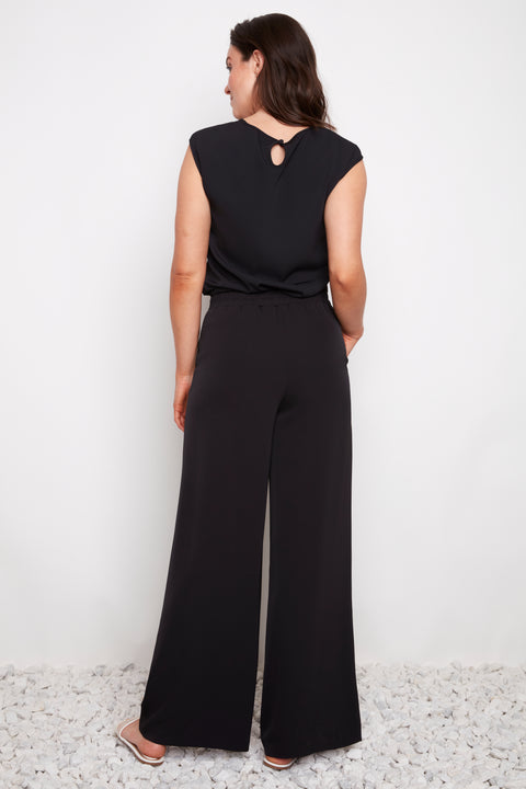 Back view of model wearing UP! Vegan Silk Wide-Leg Full-Length Pant in Black.