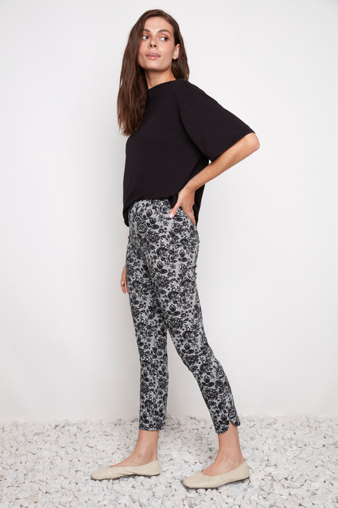 Side view of model wearing UP! Lacey Techno Petal-Slit Ankle Pant in Lacey print with petal vent detail.