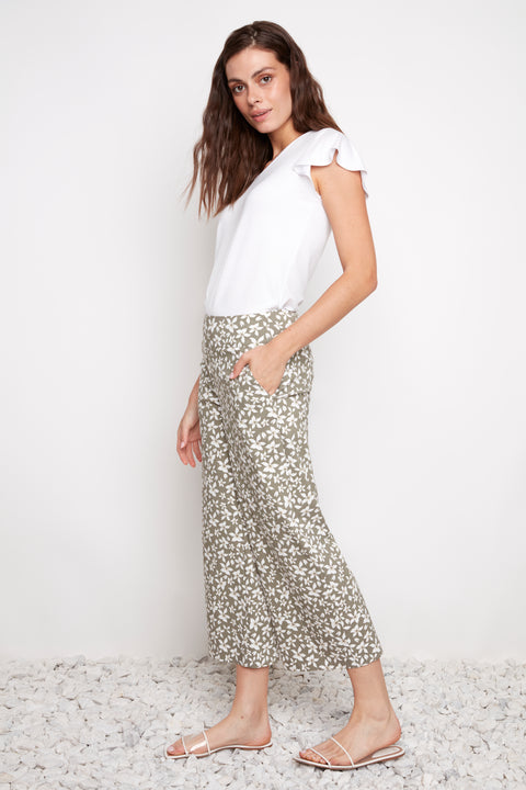 Side view of model wearing UP! Wild Daisy Techno Wide Leg Crop Pant in Wild Daisy print with angled pocket detail.