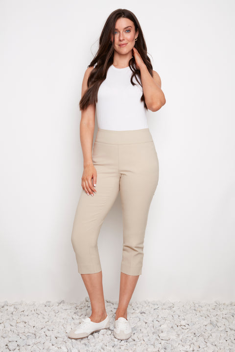 Model wearing UP! Techno Core Capri Pant in Sand, front view.