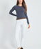 Woman wearing the Precision Ponte Slim Pant in White with Animal Print interior lining.
