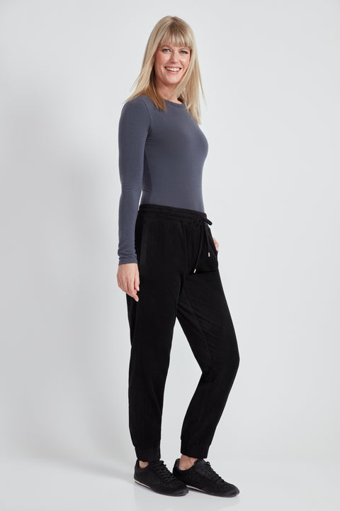 Woman wearing the Knit Corduroy Jogger in Black, side view.
