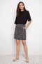 Model wearing UP! Bloom Print Techno Vented Skort in Black & White front view.