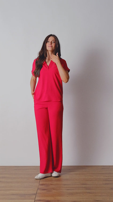 Video of model wearing UP! Air Flow Short Sleeve Top in Strawberry red, front view.